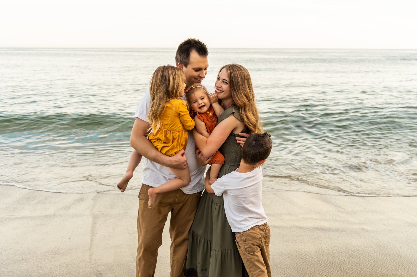 Dr. MacNeille with his wife and three children on the beach